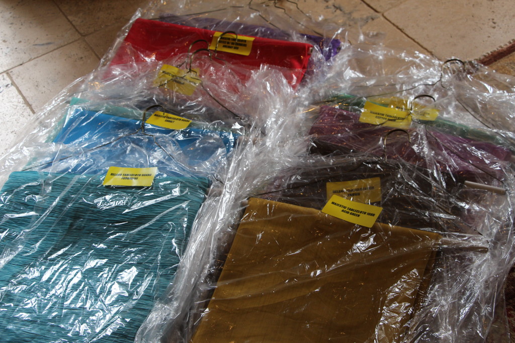 Tablecloths arrive clearly labeled by style, color, shape and size and are wrapped on hangers.